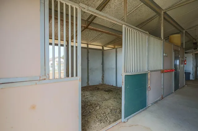 a view of a house with backyard and a car parked in front of it