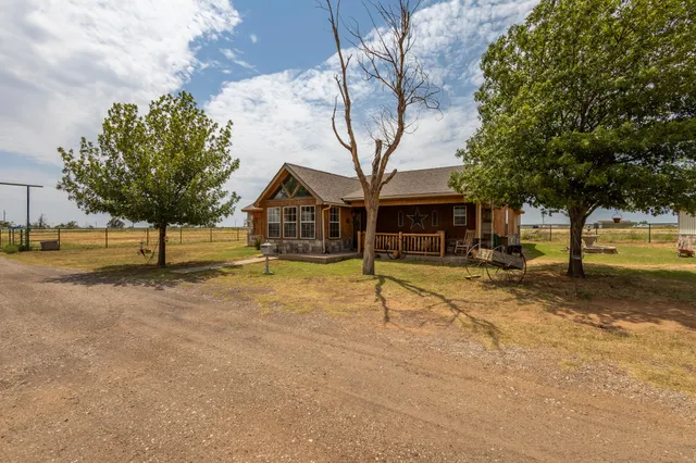 a view of a porch with a table and chairs
