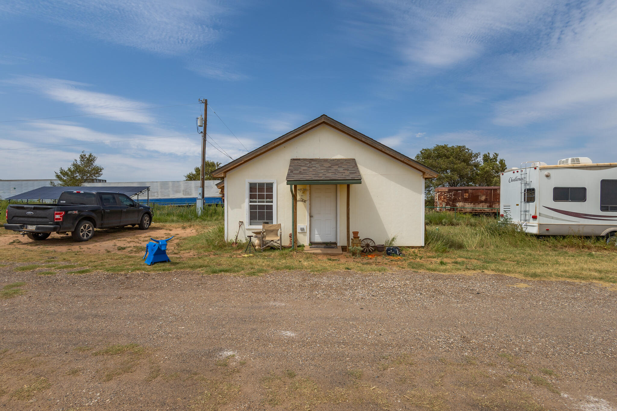 3401 East Regis Street Lubbock, TX 79403 - Photo 57 of 65 a view of a house with backyard and a car parked in front of it
