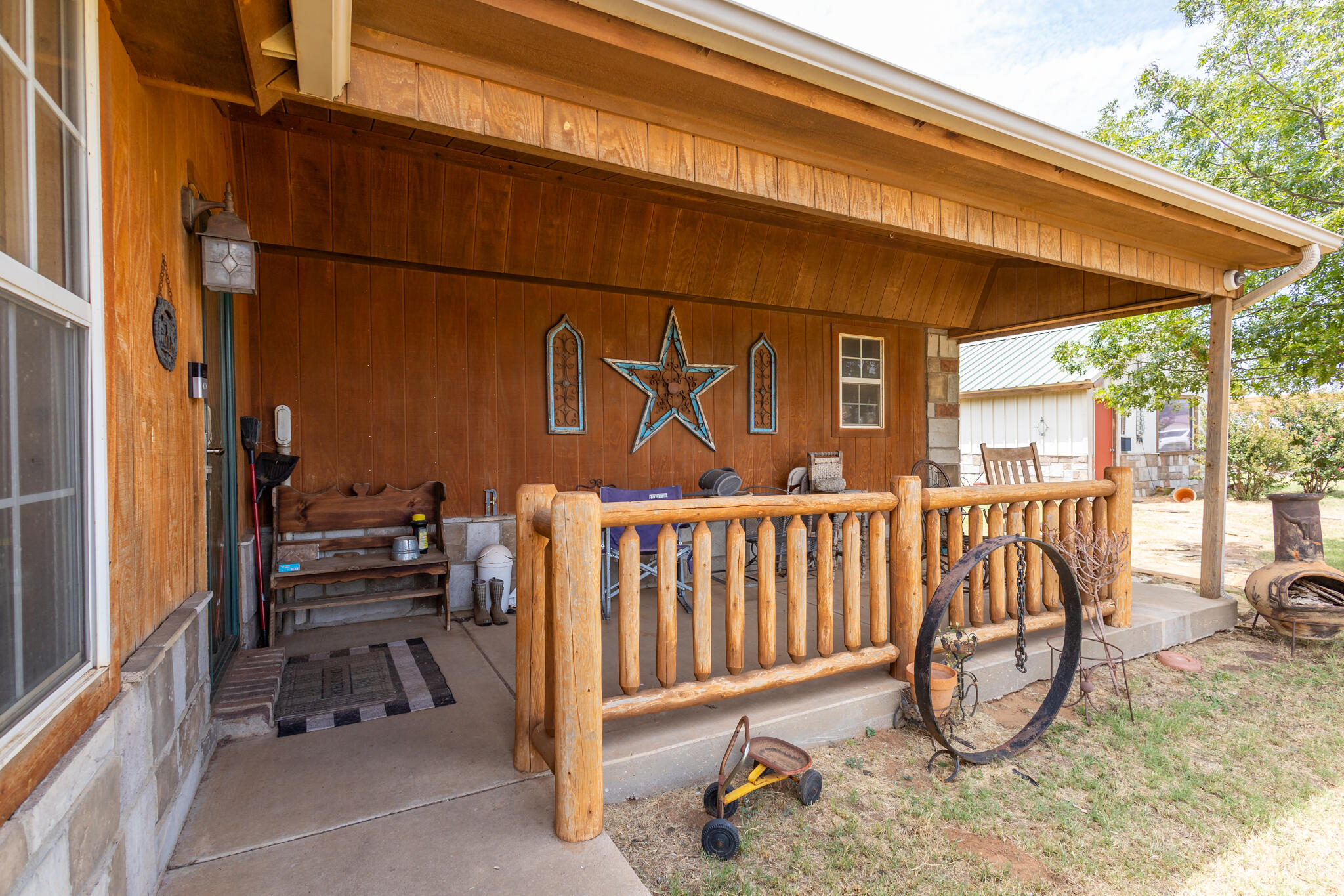 3401 East Regis Street Lubbock, TX 79403 - Photo 7 of 65 a view of a porch with a table and chairs