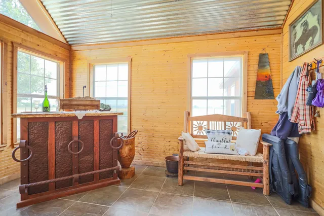 a living room with furniture a chandelier and a dining table