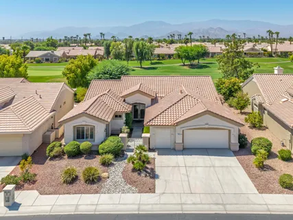 an aerial view of a house with a garden and plants