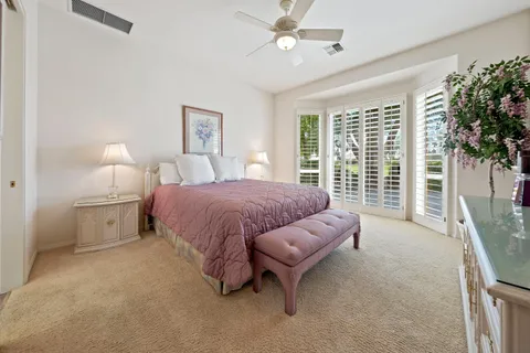 a spacious bedroom with a bed and a large window