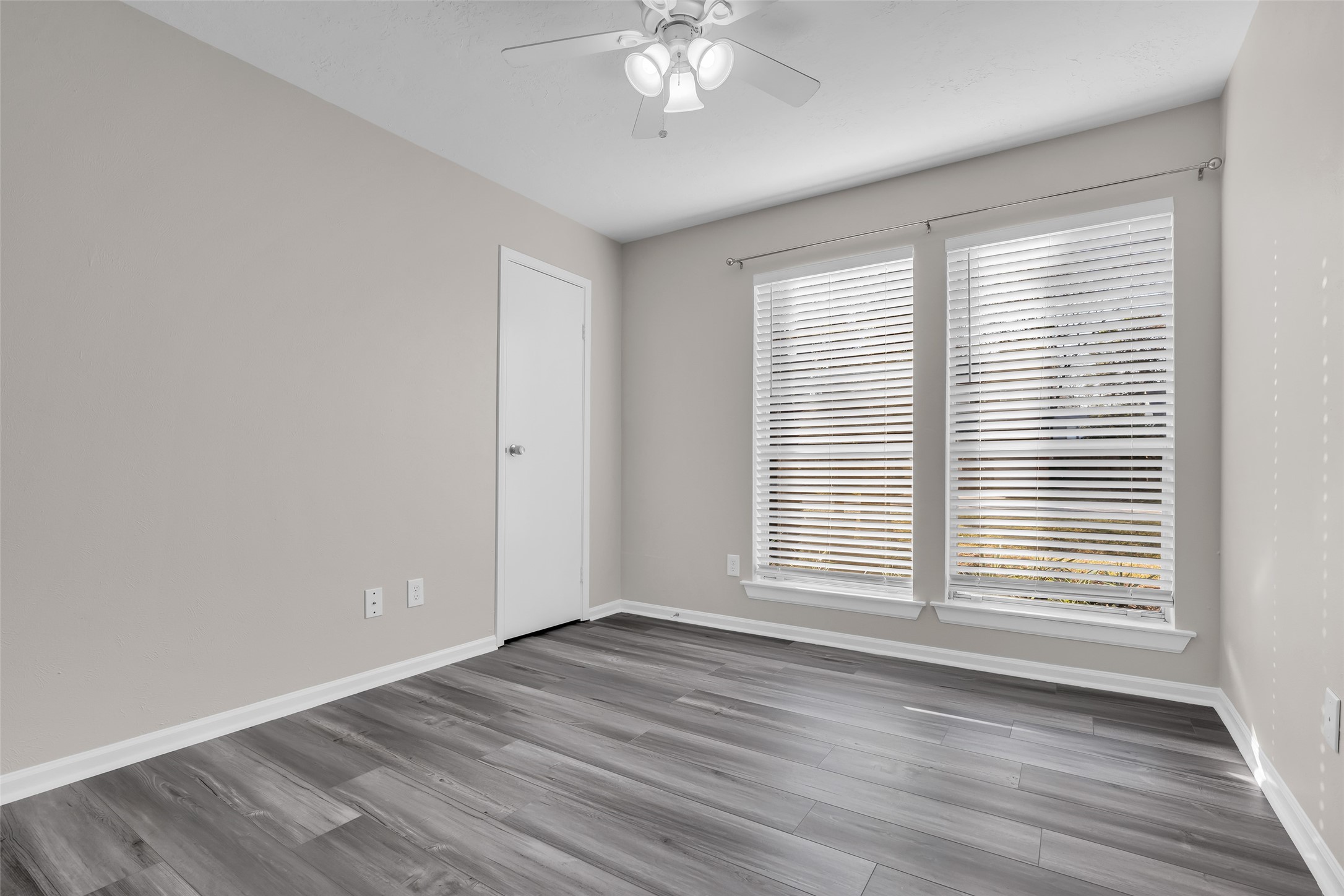 8 Still Glen Court Spring, TX 77381 - Photo 17 of 23 a view of an empty room with wooden floor and a window