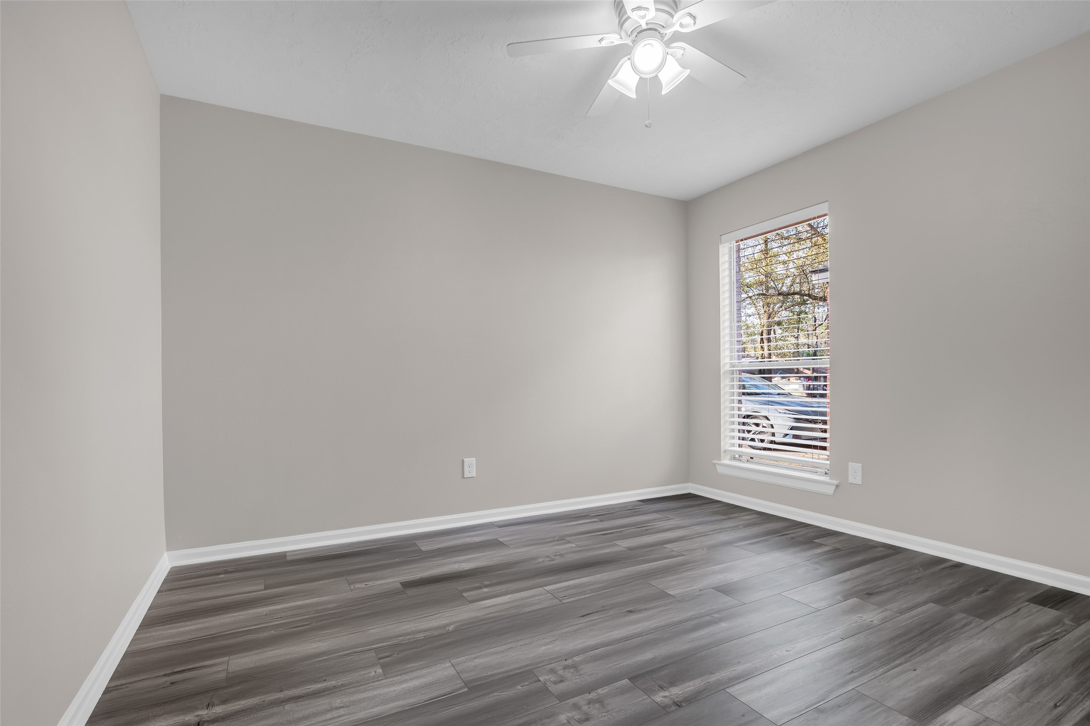 8 Still Glen Court Spring, TX 77381 - Photo 18 of 23 a view of an empty room with wooden floor and a window