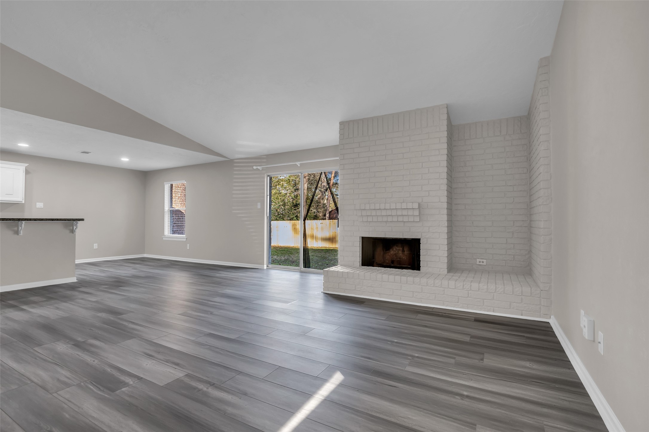 8 Still Glen Court Spring, TX 77381 - Photo 5 of 23 a view of a livingroom with wooden floor and a fireplace
