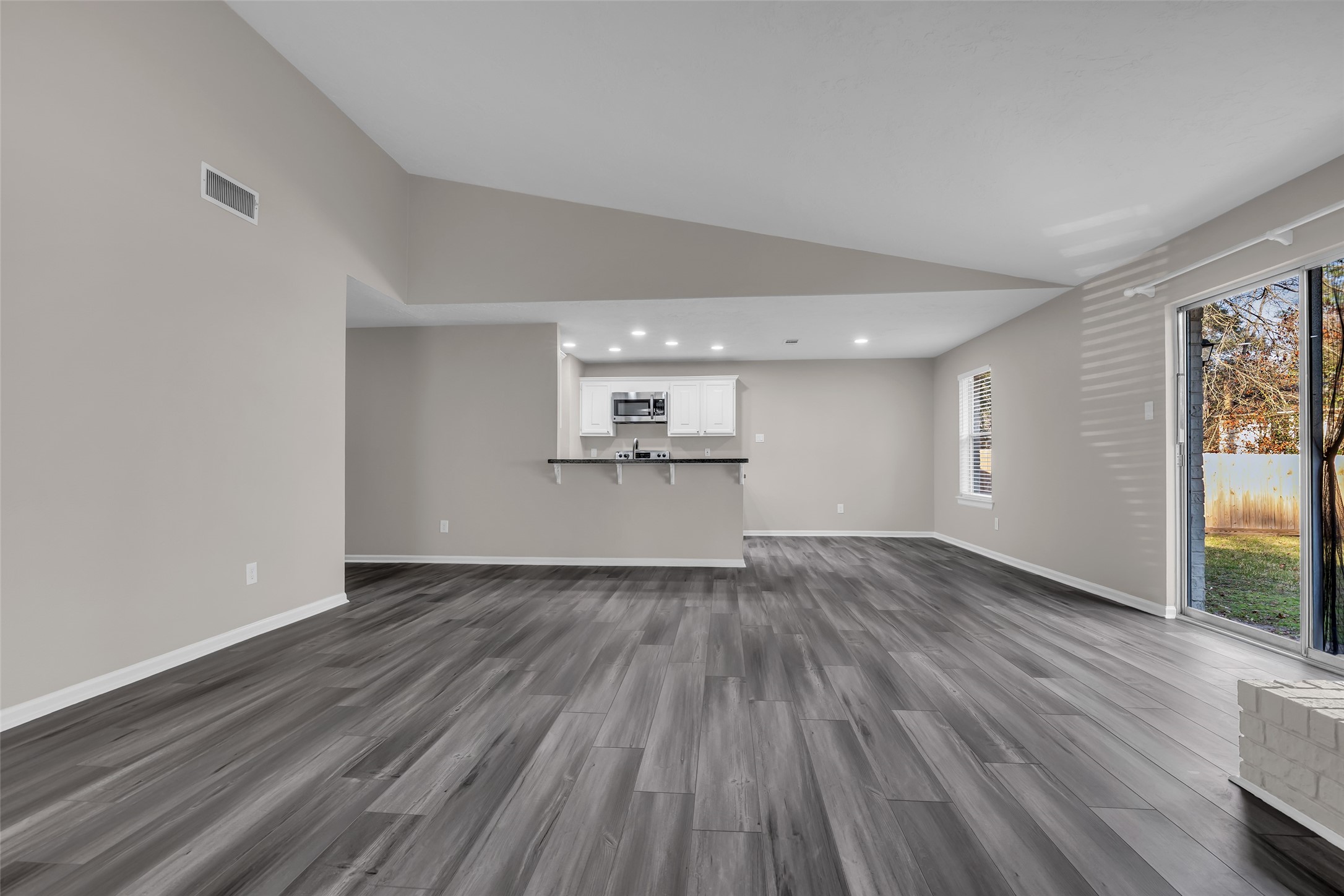 8 Still Glen Court Spring, TX 77381 - Photo 6 of 23 a view of a kitchen with wooden floor and a sink