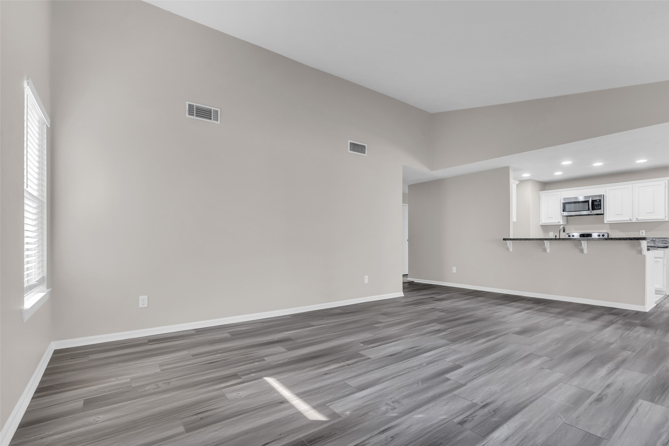8 Still Glen Court Spring, TX 77381 - Photo 7 of 23 a view of kitchen with wooden floor and window