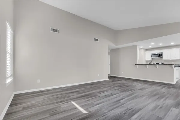 a view of kitchen with wooden floor and window