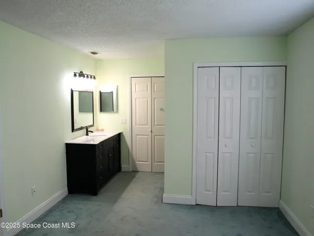 a bathroom with a double vanity sink and mirror