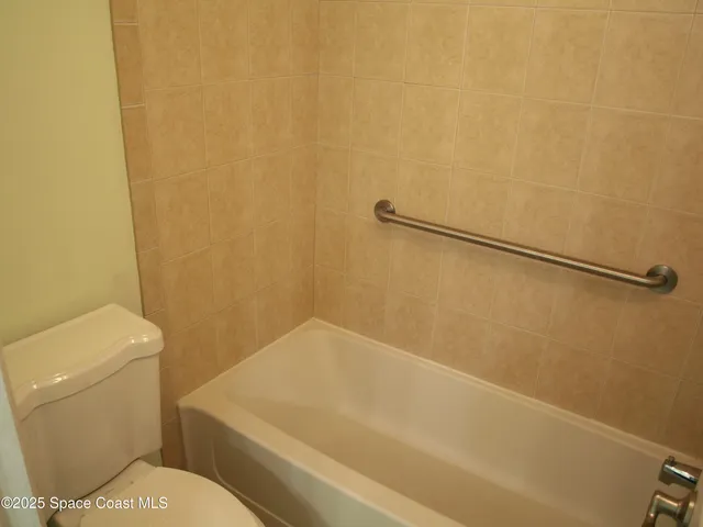 a bathroom with a toilet and a shower curtain