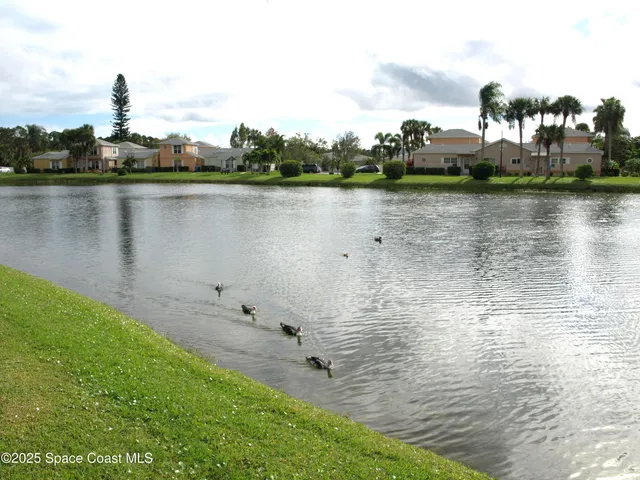a view of a lake with houses in the back