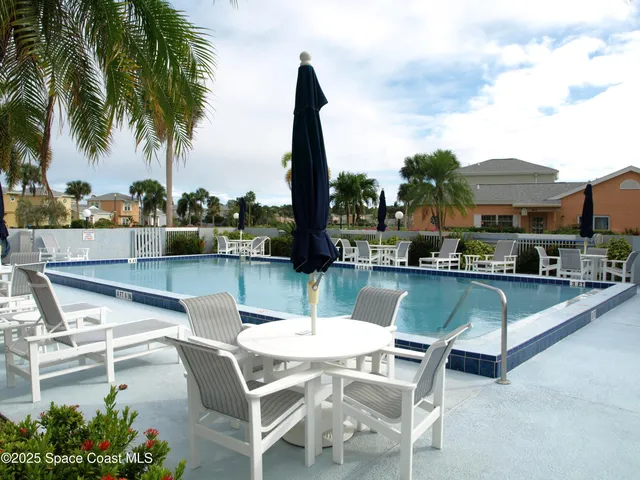 a view of a patio with chairs and a table