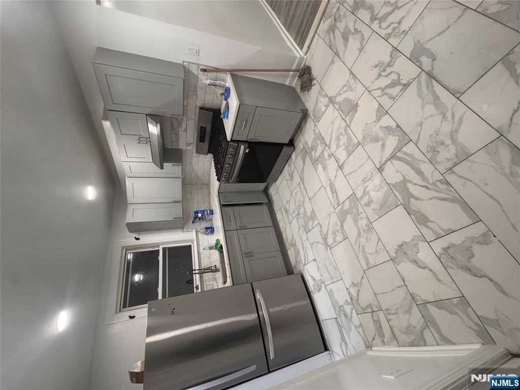 121-123 Butler Street, Unit 121 Paterson, NJ 07524 - Photo 1 of 6 a kitchen with stainless steel appliances a refrigerator sink and cabinets