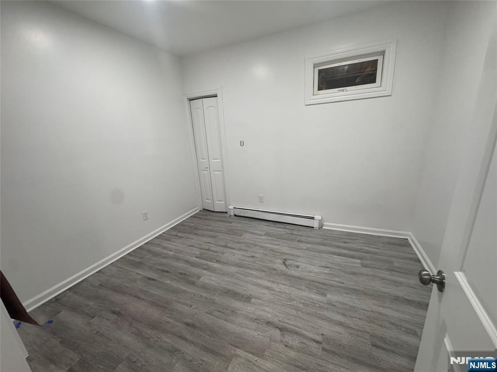 121-123 Butler Street, Unit 121 Paterson, NJ 07524 - Photo 5 of 6 wooden floor in an empty room