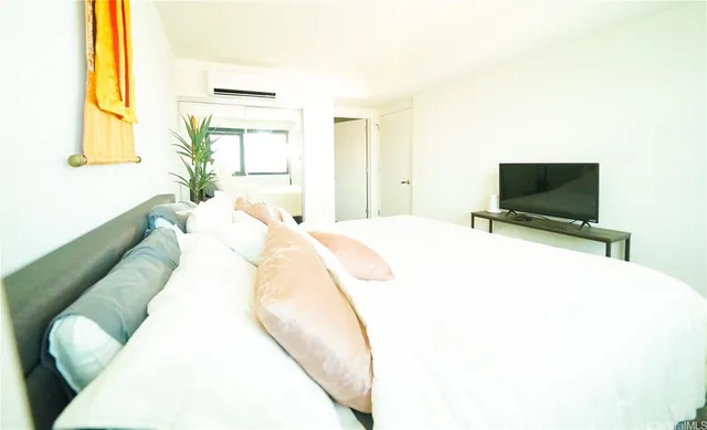 a spacious bedroom with a bed and window