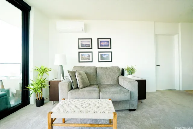 a living room with furniture and a potted plant