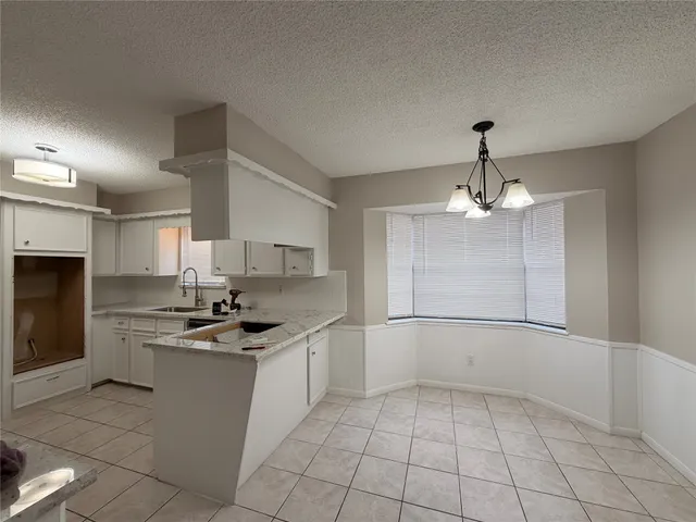 a kitchen with stainless steel appliances a sink stove and refrigerator