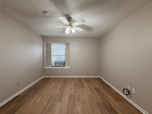 a view of a room with wooden floor and windows