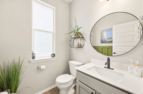 a bathroom with a sink a mirror and a toilet