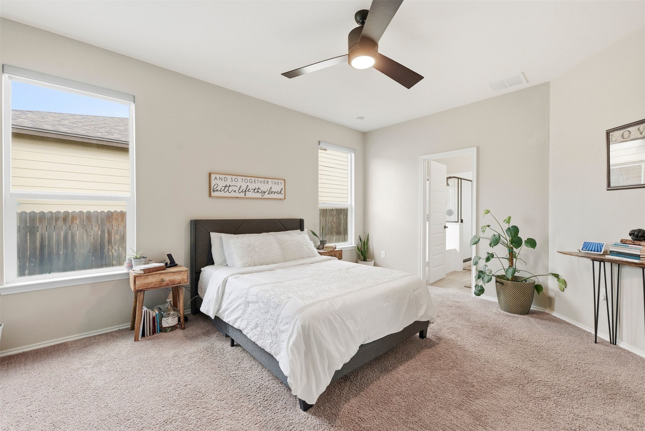 1506 Dragonfly Loop Bastrop, TX 78602 - Photo 12 of 28 Carpeted bedroom with ensuite bath and a ceiling fan