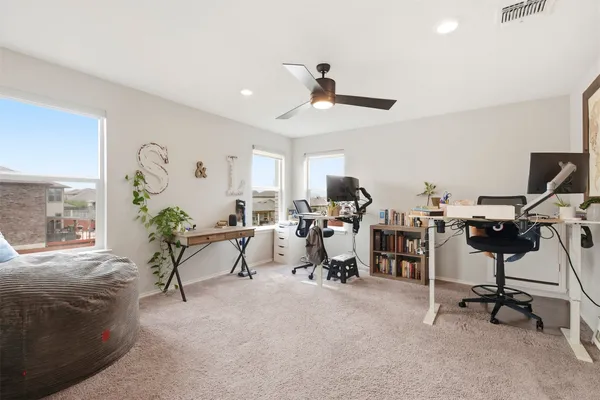 a view of a livingroom with workspace and a window