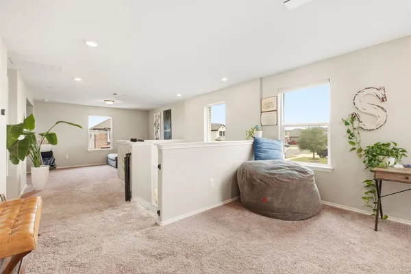 a living room with furniture a dining table and a potted plant