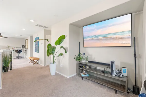 a living room with furniture gym equipment and a large window