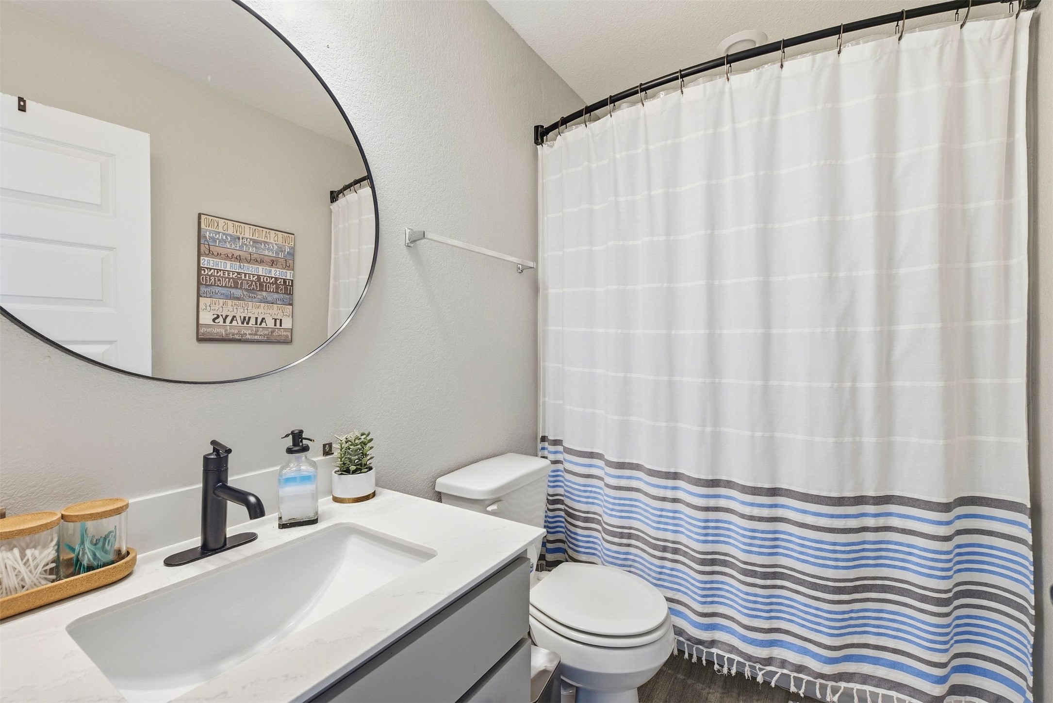 1506 Dragonfly Loop Bastrop, TX 78602 - Photo 21 of 28 Full bath featuring vanity, a shower with shower curtain, and a textured wall