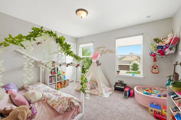 a bedroom with furniture and a book shelf
