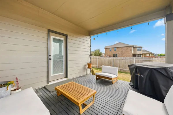a balcony with furniture and a rug