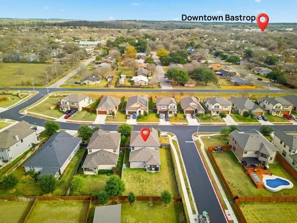 an aerial view of residential houses with outdoor space