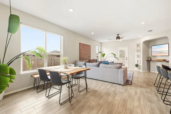 a living room with furniture and wooden floor