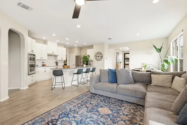 a living room with furniture and view of kitchen