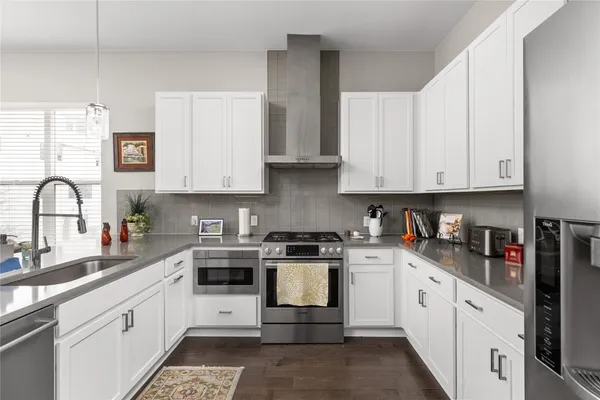 a kitchen with stainless steel appliances and view of living room