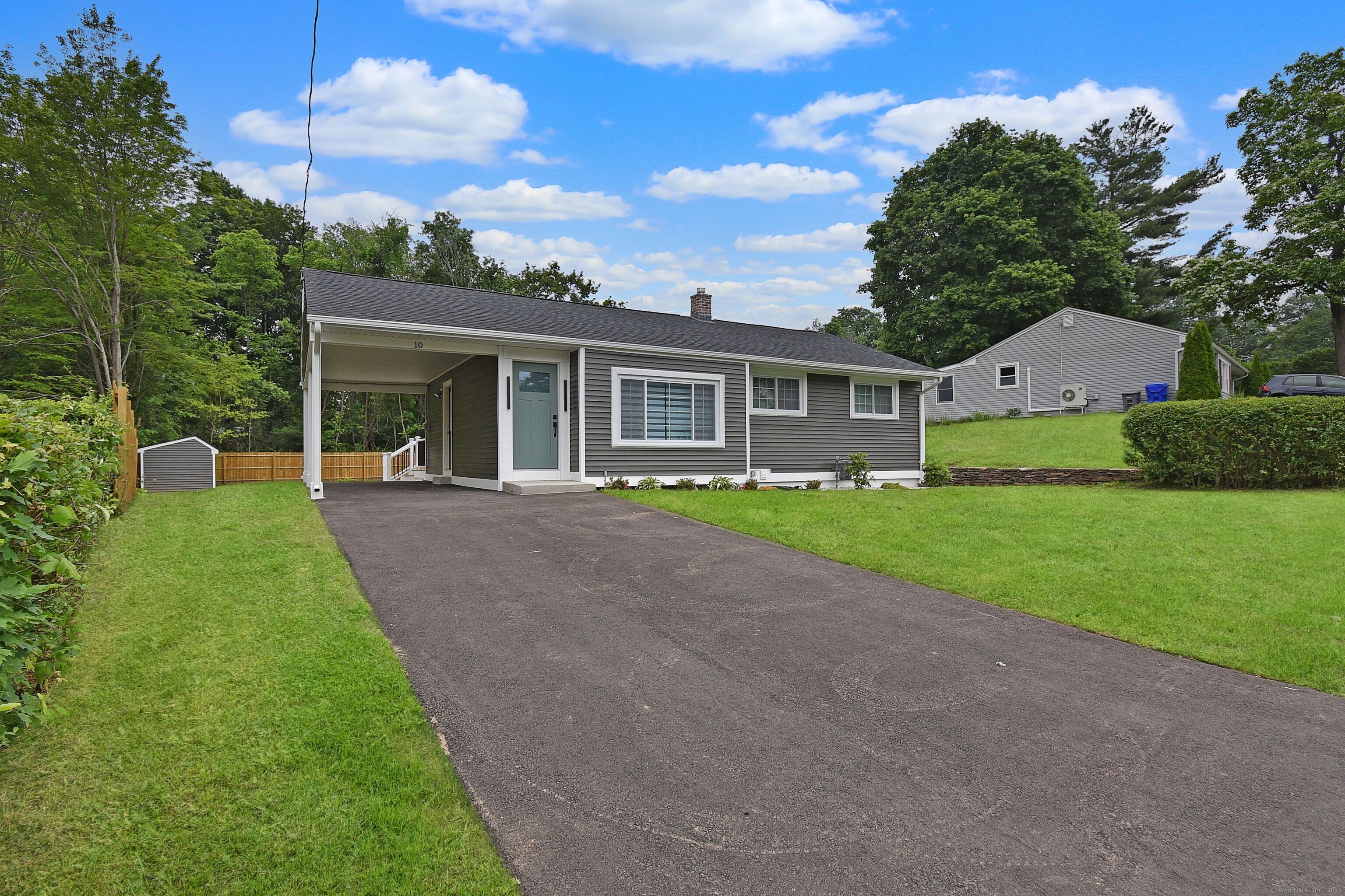a front view of house with yard and green space