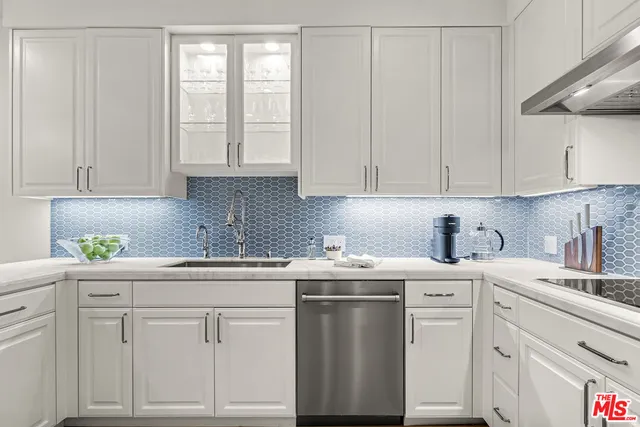 a kitchen with white cabinets and white appliances