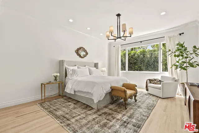 a bedroom with a bed couch and window