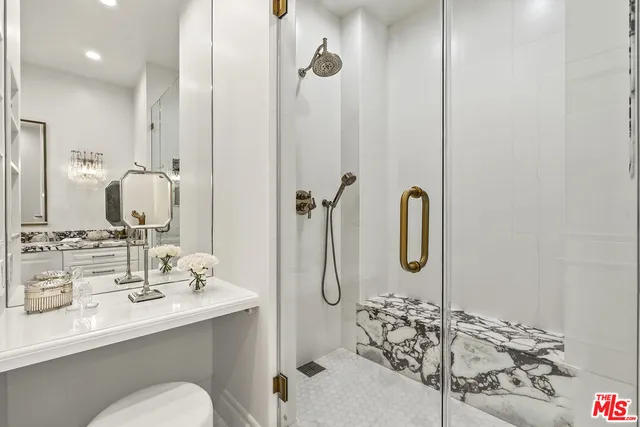 a bathroom with a double vanity sink mirror and shower