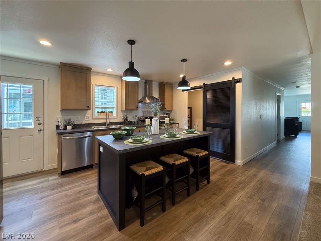 464 Box Canyon Road Alamo, NV 89001 - Photo 32 of 48 Gleaming wood-look floors pair with a dark central island and sleek stainless steel appliances.