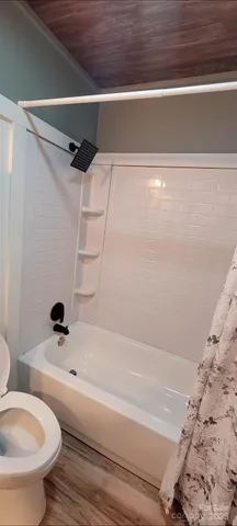 a bathroom with a bathtub and a toilet
