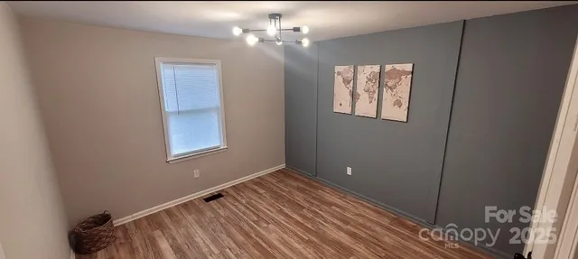 a view of hallway with wooden floor