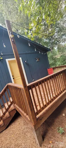 a view of balcony with wooden floor and outdoor seating