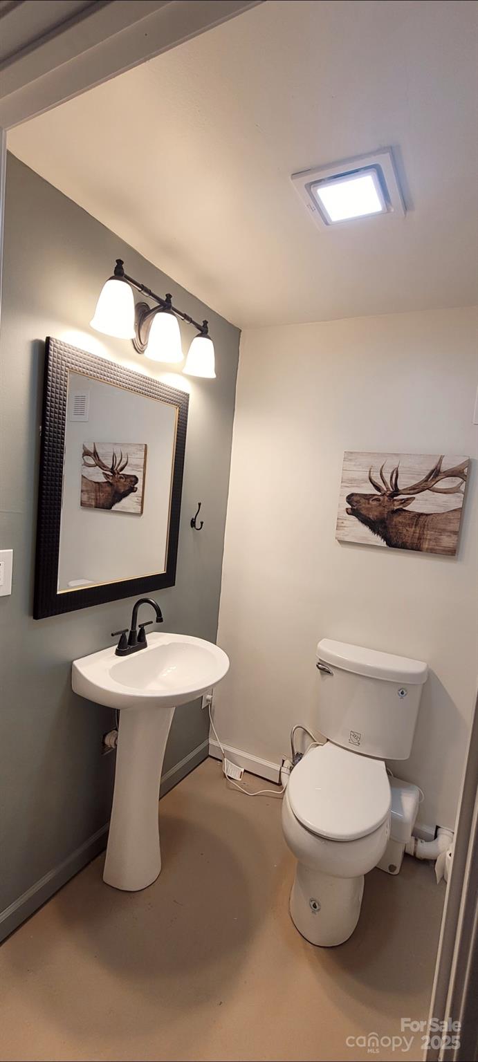 2696 Tablerock Road Lenoir, NC 28645 - Photo 25 of 36 a bathroom with a toilet a sink and mirror