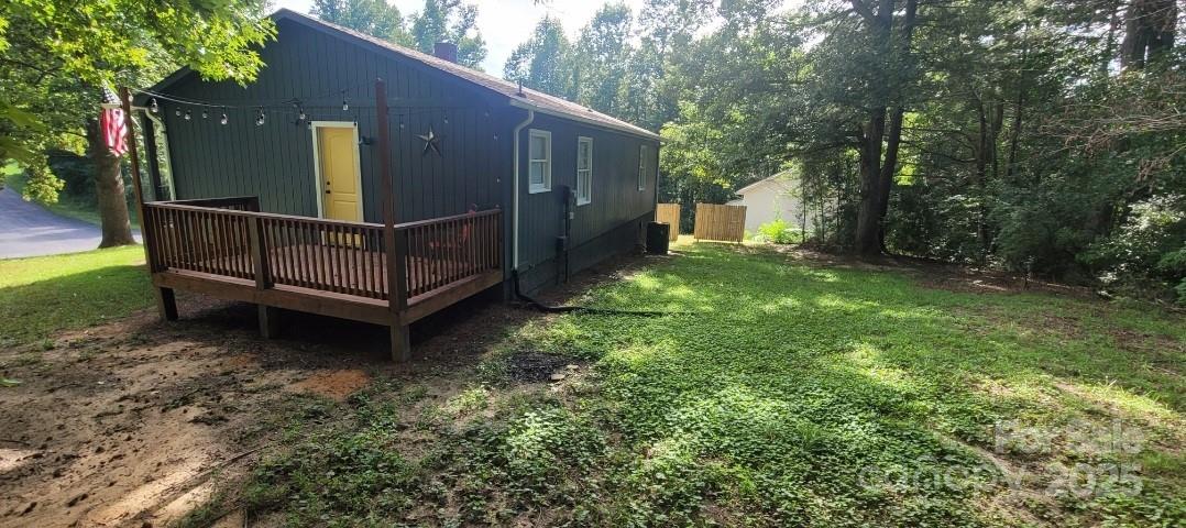 2696 Tablerock Road Lenoir, NC 28645 - Photo 36 of 36 a view of a house with a small yard and wooden fence