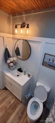 a bathroom with a toilet sink and mirror
