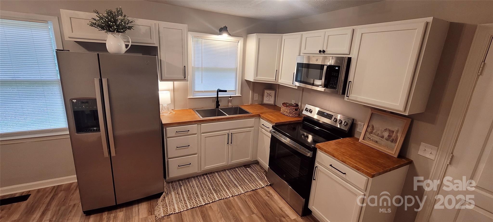 2696 Tablerock Road Lenoir, NC 28645 - Photo 5 of 36 a kitchen with stainless steel appliances a refrigerator stove and sink