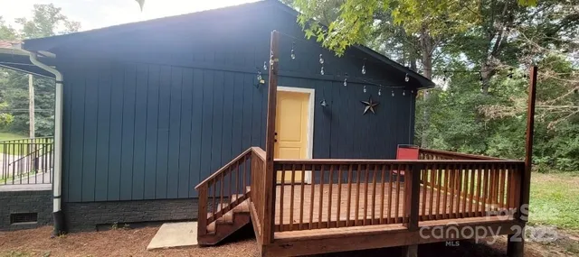 a view of a balcony with wooden floor and a potted plant