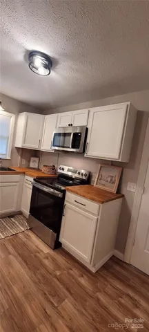 a kitchen with stainless steel appliances granite countertop a stove and a sink