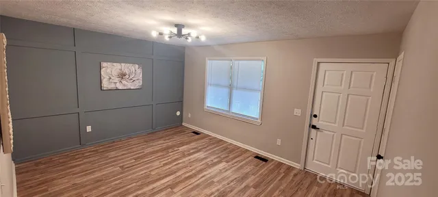 a view of a room with wooden floor